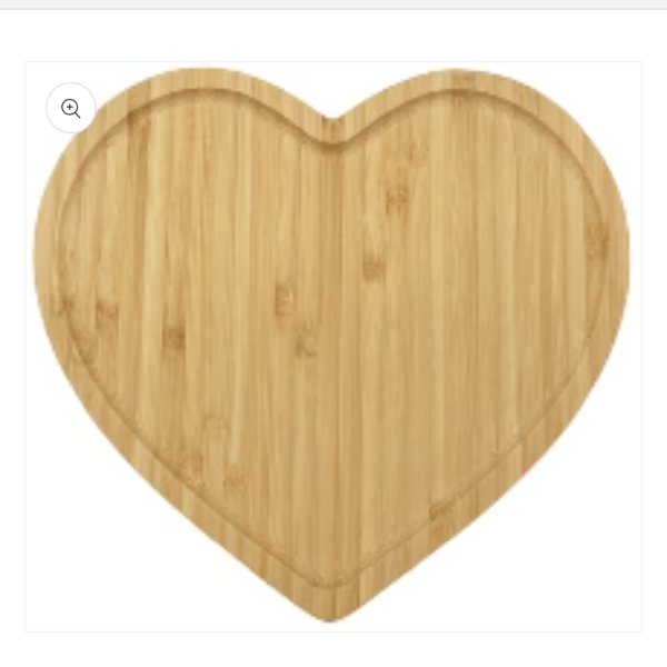 Heart-shaped wooden cutting board on a white background