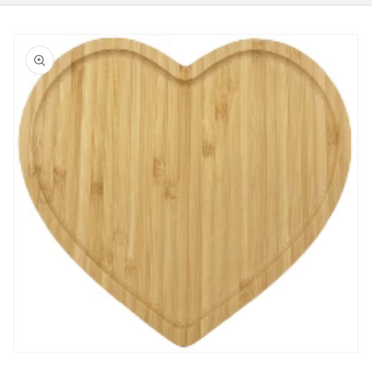 Heart-shaped wooden cutting board on a white background